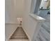 Carpeted staircase leading to the ground floor with white painted walls and trim at 2220 Chianti Pl # 8-0828, Palm Harbor, FL 34683