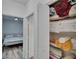 Storage closet with shelving, holding towels, blankets and bathroom linens, and bedroom beyond at 2220 Chianti Pl # 8-0828, Palm Harbor, FL 34683