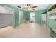 The bedroom boasts vibrant walls and neutral flooring, complemented by a ceiling fan and ample closet space at 2485 Indigo Dr, Clearwater, FL 33763