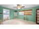 The bedroom features bright walls, neutral flooring, a ceiling fan, and an adjacent bathroom at 2485 Indigo Dr, Clearwater, FL 33763