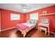 Inviting bedroom with warm hardwood floors, natural light, and a cozy bed setup at 2485 Indigo Dr, Clearwater, FL 33763