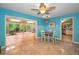 Open dining area with tile floors, ceiling fan, and adjacent screened-in porch at 2485 Indigo Dr, Clearwater, FL 33763