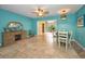 Inviting dining room with turquoise walls, tile floors, and a ceiling fan at 2485 Indigo Dr, Clearwater, FL 33763