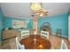 Comfortable dining area with a decorative ceiling fan and tiled flooring at 2485 Indigo Dr, Clearwater, FL 33763
