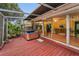 Exterior deck with a hot tub and views of the enclosed sun room at 2485 Indigo Dr, Clearwater, FL 33763
