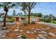Charming yellow single-story home with a red door, well-manicured landscaping and an attached garage at 2485 Indigo Dr, Clearwater, FL 33763