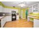 The kitchen features white cabinets, stainless steel appliances, and hardwood flooring at 2485 Indigo Dr, Clearwater, FL 33763