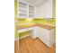 Kitchen with white cabinets, laminate floors, and granite countertops at 2485 Indigo Dr, Clearwater, FL 33763