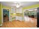Bright kitchen with white cabinetry and adjacent sunroom at 2485 Indigo Dr, Clearwater, FL 33763