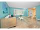 Inviting living room with tile flooring, shuttered windows, and a colorful accent wall at 2485 Indigo Dr, Clearwater, FL 33763