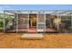 Enclosed sunroom boasting a hot tub, wood flooring, brick accents, and access to the serene backyard at 2485 Indigo Dr, Clearwater, FL 33763