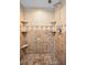 The tiled walk-in shower features tiled walls, multiple shelves, and a shower head at 2485 Indigo Dr, Clearwater, FL 33763