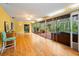 Spacious sunroom with wood floors and a hot tub surrounded by greenery at 2485 Indigo Dr, Clearwater, FL 33763
