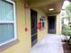 View of a unit exterior with a front door, windows, and emergency equipment at 2500 Harn Blvd # A5, Clearwater, FL 33764