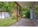 Covered back porch, featuring wooden posts and a wooden deck at 2814 W Humphrey St, Tampa, FL 33614