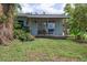 A tranquil backyard featuring a cozy back porch and plenty of greenery at 2814 W Humphrey St, Tampa, FL 33614