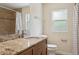 Bathroom featuring a granite countertop and shower with tile at 2814 W Humphrey St, Tampa, FL 33614