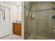 Modern bathroom showcasing a tiled walk-in shower with glass door and a vanity at 2814 W Humphrey St, Tampa, FL 33614
