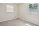 Bedroom with neutral carpet and two windows at 2814 W Humphrey St, Tampa, FL 33614