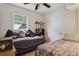 Cozy bedroom with a ceiling fan, window, and two beds at 2814 W Humphrey St, Tampa, FL 33614