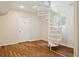 Finished bonus room with white spiral staircase and wood flooring provides access to upper level at 2814 W Humphrey St, Tampa, FL 33614