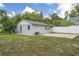 Charming home exterior with well-manicured lawn, partial fencing and patio for relaxing and entertaining at 2814 W Humphrey St, Tampa, FL 33614