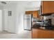 Well-appointed kitchen featuring stainless appliances, stone countertops and wooden cabinetry at 2814 W Humphrey St, Tampa, FL 33614