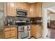 Close up of kitchen featuring wood cabinets, stainless steel appliances, and granite countertops at 2814 W Humphrey St, Tampa, FL 33614