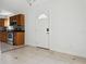 Bright kitchen area features tile flooring, stainless appliances, wood cabinets and door to outside at 2814 W Humphrey St, Tampa, FL 33614