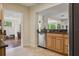 View of the kitchen featuring wooden cabinets, stainless steel dishwasher, and granite countertop at 2814 W Humphrey St, Tampa, FL 33614