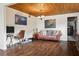 Inviting living room with hardwood floors, a comfortable sofa, and a unique wood ceiling at 2814 W Humphrey St, Tampa, FL 33614