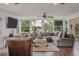 Bright living room featuring hardwood floors, comfortable seating, and views of the lake at 2814 W Humphrey St, Tampa, FL 33614