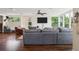 Bright living room with hardwood floors, plush seating, a ceiling fan, and large windows at 2814 W Humphrey St, Tampa, FL 33614