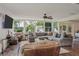 Cozy living room featuring hardwood floors, comfortable seating, and views of the lake at 2814 W Humphrey St, Tampa, FL 33614