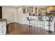 Open concept living room featuring hardwood floors and a bar area with seating at 2814 W Humphrey St, Tampa, FL 33614