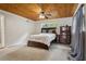 Spacious main bedroom featuring a wood plank ceiling, dresser and natural light at 2814 W Humphrey St, Tampa, FL 33614