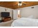 View of main bedroom leading to bath featuring a wood plank ceiling and natural light at 2814 W Humphrey St, Tampa, FL 33614