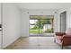 Well-lit seating area with sliding glass door access to fenced-in patio and backyard at 2814 W Humphrey St, Tampa, FL 33614