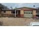 Single-story home featuring a red and tan brick facade with an attached garage at 2817 Miriam S St, Gulfport, FL 33711