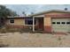 Single-story home featuring a red and tan brick facade with an attached garage at 2817 Miriam S St, Gulfport, FL 33711