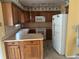 The kitchen features wood cabinets, laminate countertops, and white appliances at 2817 Miriam S St, Gulfport, FL 33711
