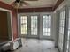 Sunroom boasts tiled floors and multiple sets of glass French doors at 2817 Miriam S St, Gulfport, FL 33711