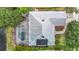 An aerial view features a screened pool, lush landscaping, and updated roof at 3001 Regal Oaks Blvd, Palm Harbor, FL 34684