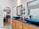 Bathroom featuring granite countertop, vessel sinks, decorative tile, and access to the main bedroom at 3001 Regal Oaks Blvd, Palm Harbor, FL 34684