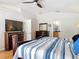 Spacious bedroom with a ceiling fan, closet, TV and en-suite bathroom at 3001 Regal Oaks Blvd, Palm Harbor, FL 34684