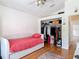 Bedroom with hardwood floors, daybed and closet at 3001 Regal Oaks Blvd, Palm Harbor, FL 34684