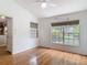 Bedroom featuring hardwood floors and two large windows for ample natural light at 3001 Regal Oaks Blvd, Palm Harbor, FL 34684