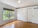 Bright bedroom with hardwood floors and large window at 3001 Regal Oaks Blvd, Palm Harbor, FL 34684