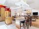 Open kitchen layout with granite countertops, an island with seating, and seamless integration to the living space at 3001 Regal Oaks Blvd, Palm Harbor, FL 34684