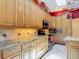 Close-up of the kitchen with light wood cabinets, decorative tile backsplash, and granite countertops at 3001 Regal Oaks Blvd, Palm Harbor, FL 34684